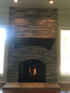 metal fireplace door and stone exterior
