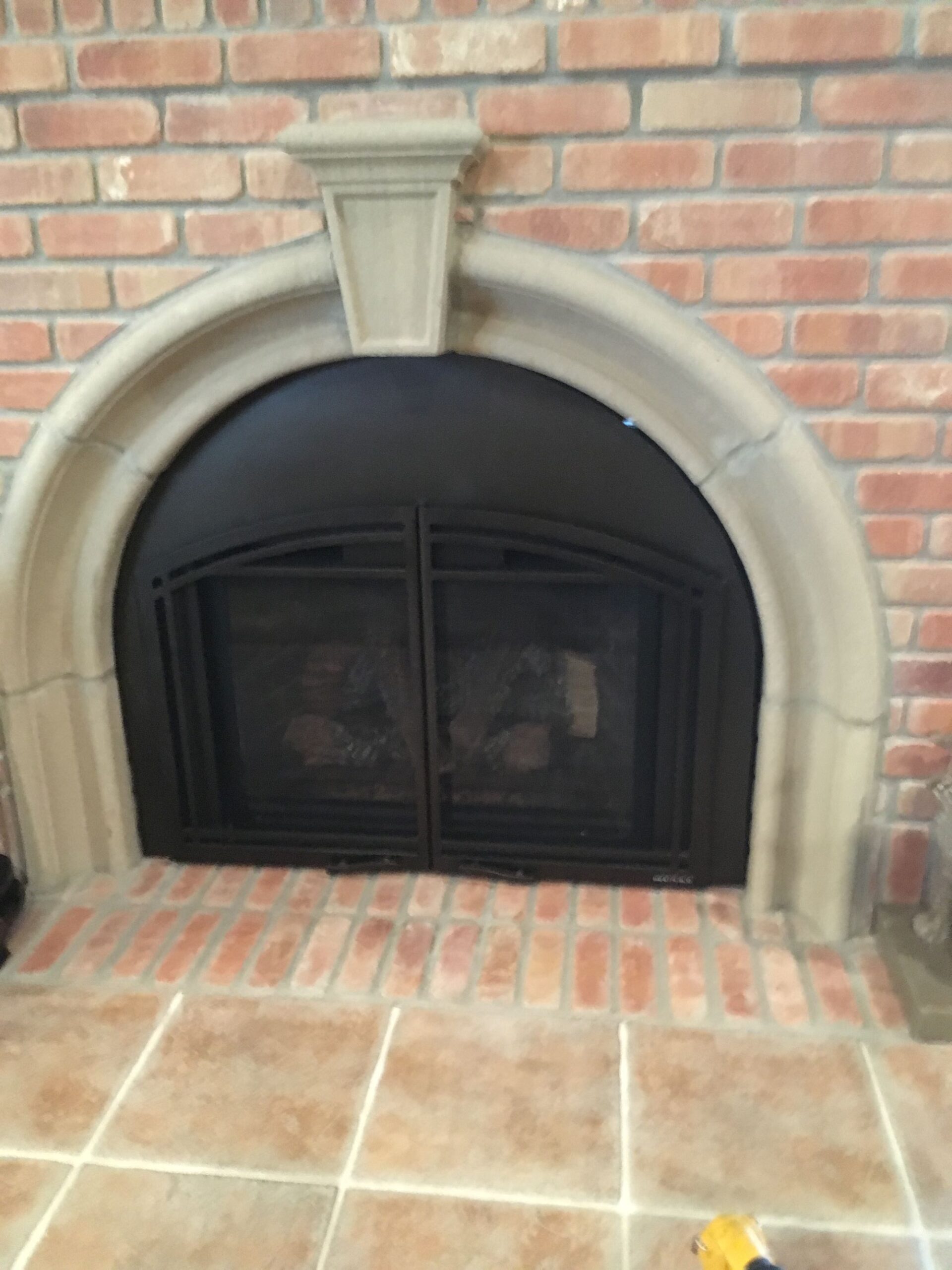 metal fireplace inlaid in brick